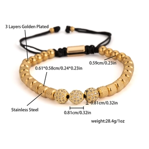 Macro detail of gold plated beads and zircon spheres on black braided adjustable bracelet