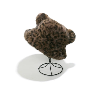Detail of leopard print faux fur bucket hat with bear ears on a metal display stand