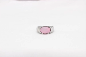 Macro detail of oval pink gemstone set in a minimalist silver stainless steel ring band