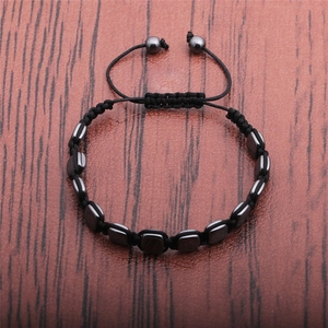 Detail of adjustable black woven rope bracelet with polished hematite rectangular beads