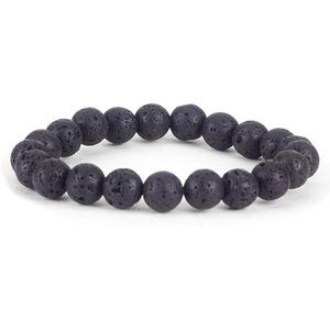 Macro shot of natural porous black lava stone beads on a stretch bracelet with texture