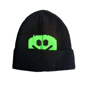 Japanese style black knit beanie with a bright green pixel smiley face pattern for women
