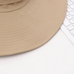 Macro shot of khaki sun hat brim featuring tight reinforced multi-row stitching detail