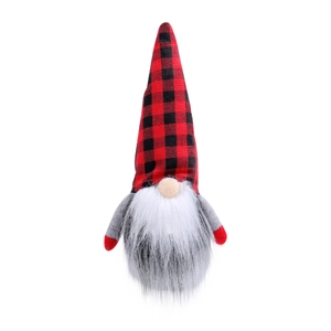 Christmas gnome doll with red and black plaid hat and white beard on white background
