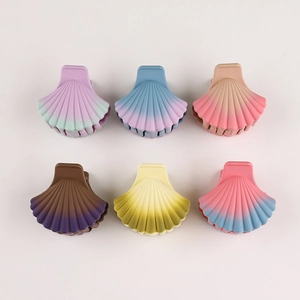 Detailed flat lay of gradient shell hair clips in matte purple, blue and pink pastel colors