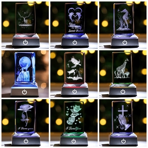 Collage of 3D laser-engraved crystal cubes with animals and flowers on glowing LED bases