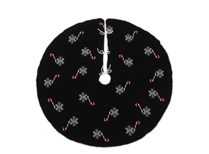 Detail view of black knitted Christmas tree skirt with snowflake and candy cane patterns