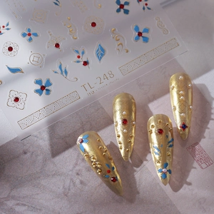 3D floral nail stickers TL-248 with blue flowers and gold accents on gold fake nails