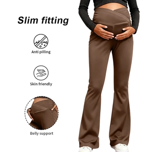 Detail of cross-over belly support on dark brown maternity yoga flare pants