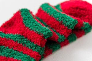 Detail of soft fuzzy red and green striped coral fleece fabric for Christmas socks