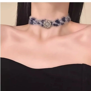 Detail view of plush faux fur choker necklace with sparkling rhinestone star pendant