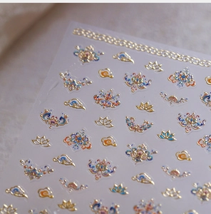 Macro view of Chinese style nail stickers featuring gold foil lotus and cloud patterns