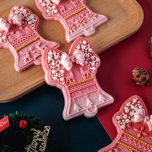 Christmas bell fondant cookie mold set with festive pink frosting and pearl decorations