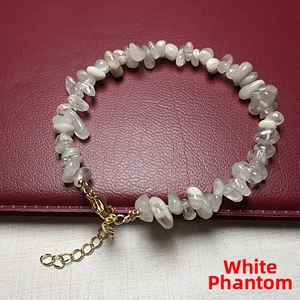 Close-up of white phantom crystal chip bracelet with golden clasp and extender