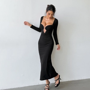 Close-up of sequin lace trim and mesh cut-out on a black deep V-neck evening gown