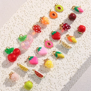 Detailed macro view of mixed colorful enamel fruit pendants in gold finish