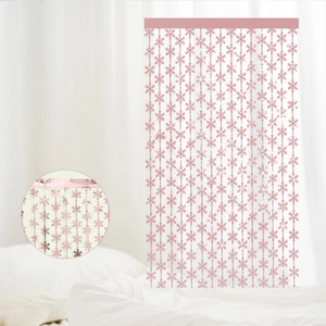 Close-up of pink snowflake fringe curtain with metallic foil finish for party decor