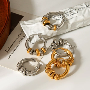 Detailed view of luxury geometric textured hoop earrings in gold and silver finishes