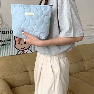 Quilted light blue floral makeup bag with a soft puffy texture for daily storage