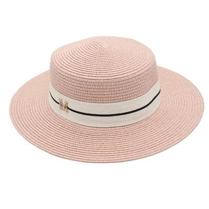 Close-up of pink straw bucket hat featuring white ribbon and golden M letter buckle