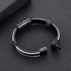 Dettaglio del bracciale multistrato da uomo in pelle con filo d'acciaio intrecciato e fibbia