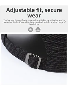 Detail of black canvas baseball cap with adjustable silver metal buckle and solid strap