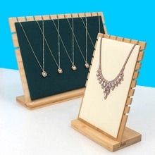 Detail of wooden jewelry display stands featuring green and beige necklace organizers