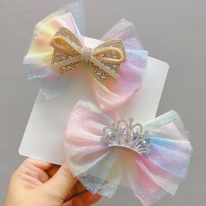 Detail of gradient mesh hair bows for girls with sparkling rhinestone crown and butterfly
