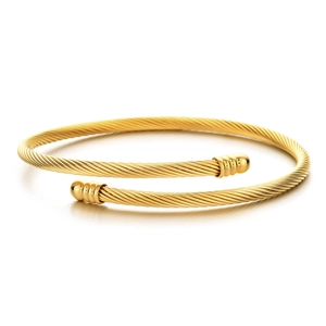 Gold cable twist bangle with polished spherical end caps and woven wire texture