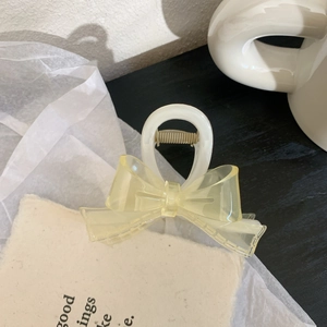 Pince à cheveux élégante en résine jaune givrée avec un design de nœud délicat