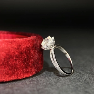 Sparkling 925 sterling silver ring with 1 carat moissanite on a red velvet jewelry box