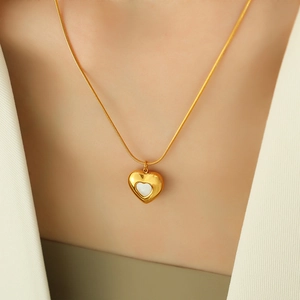 Gold heart pendant necklace with white shell inlay on a sleek snake chain for women