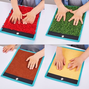 Close-up of sensory tactile pads showing diverse textures like grass and velvet fabrics