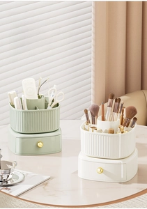 Close-up of double-layer makeup organizer with drawers and striped texture in green and cream