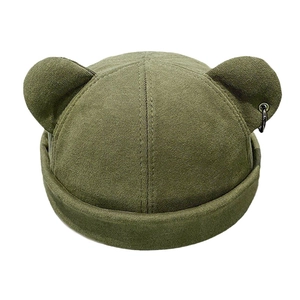 Detail of army green beanie with bear ears and a stylish black metal ring accent
