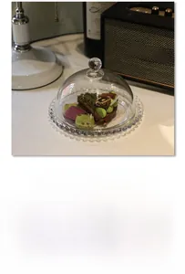 Detailed view of clear glass snack plate with beaded edge and round dome lid cover