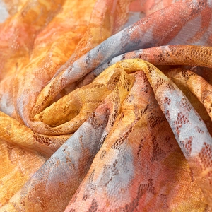 Detailed macro view of colorful lace mesh fabric with intricate hollow knit textures
