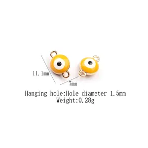 Detail of yellow enamel evil eye charms with gold edges showing size of 11.1mm x 7mm
