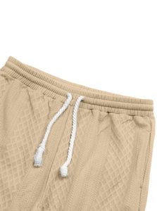 Macro detail of khaki jacquard textured waist with thick white cotton drawstrings