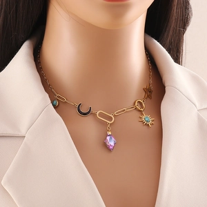 Gold stainless steel necklace with celestial charms and a purple crystal pendant