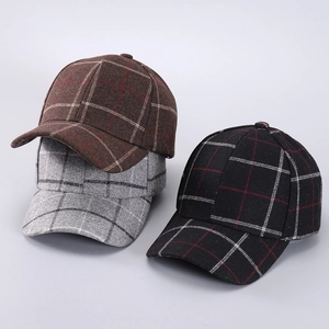 Close-up of wool houndstooth baseball caps in brown, gray and black patterns