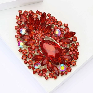 Vintage large gold drop brooch with red water-drop stones and crystals on white background