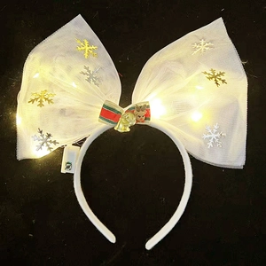 Detail of LED light-up Christmas headband with white tulle bow and reindeer charm