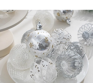 Close-up of 8cm white and silver Christmas balls with glitter snowflake patterns in a tray