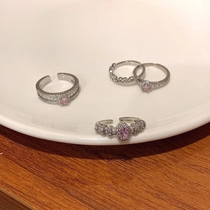 Macro shot of a four-piece S925 silver ring set with pink zircon and micro-pave details