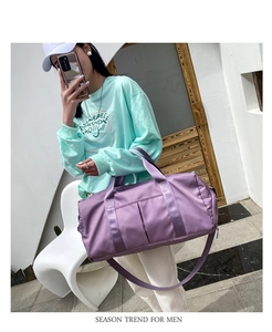 Detailed side view of purple nylon gym bag featuring wet/dry storage and shoulder strap