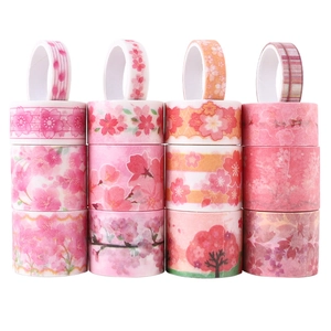 Macro detail of 16-roll pink cherry blossom washi tape set with gold foil accents