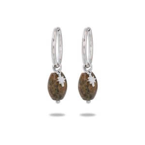 Macro shot of silver hoop earrings with oval brown stone and star-shaped pendant detail