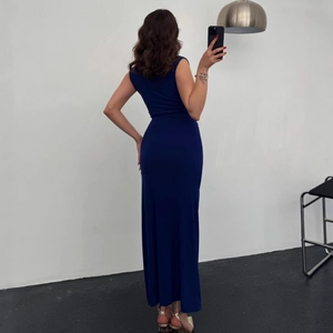 Detail of navy blue sleeveless maxi dress showing slim fit cut and elegant floor length drape