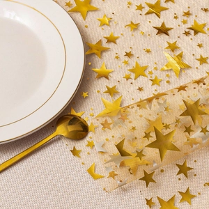 Detail of gold star mesh table runner with metallic sequins for festive table settings